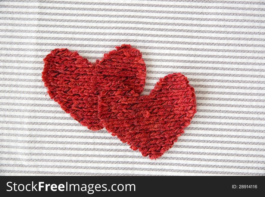 Two red hearts on striped background