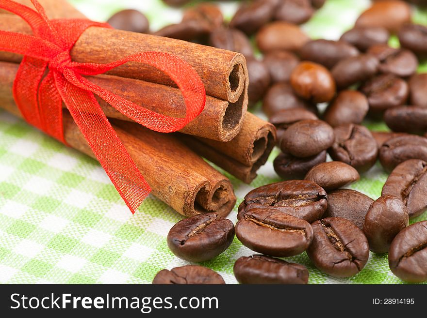 Cinnamon sticks with red ribbon and coffee beans. Cinnamon sticks with red ribbon and coffee beans