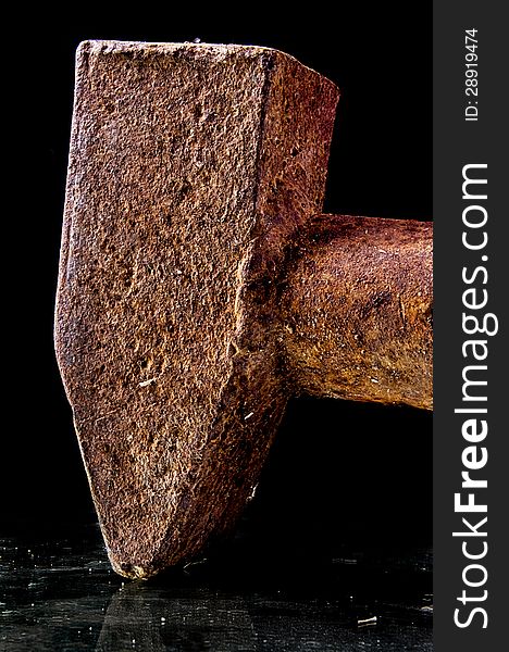 A sledge-hammer very rusted on black background. A sledge-hammer very rusted on black background