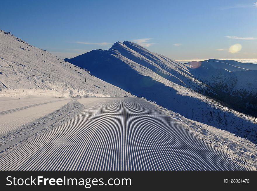 Extensive ski piste and powder snow off piste Snow grooming machine tracks - Slovac ski resort - Jasna