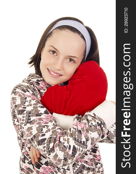 Beautiful young girl hugging heart shape pillow isolated on white