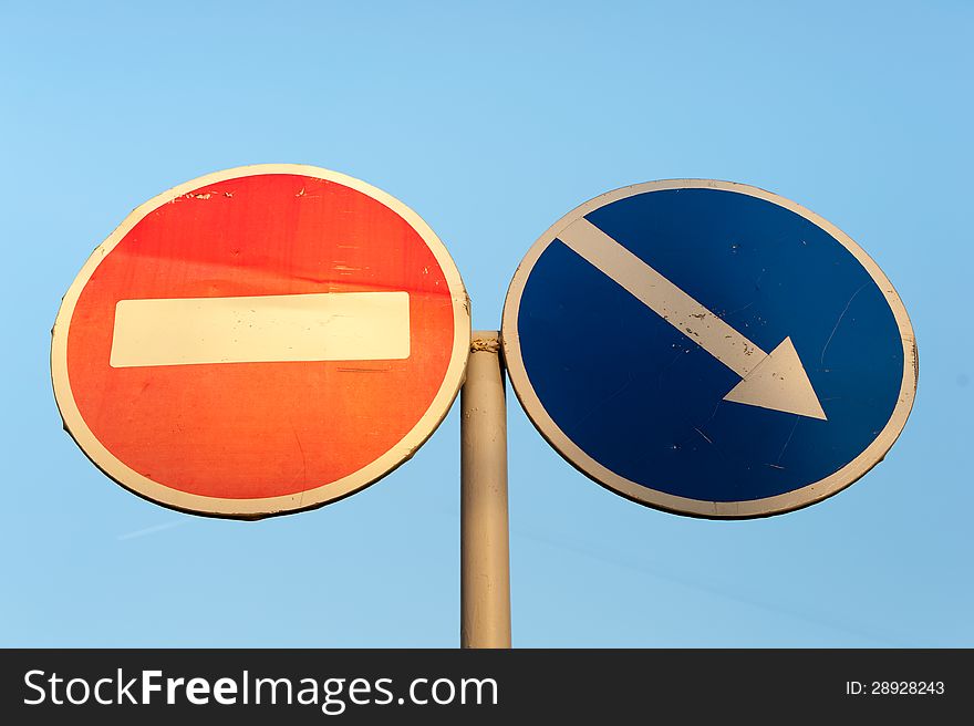 Two Signs on Blue Background