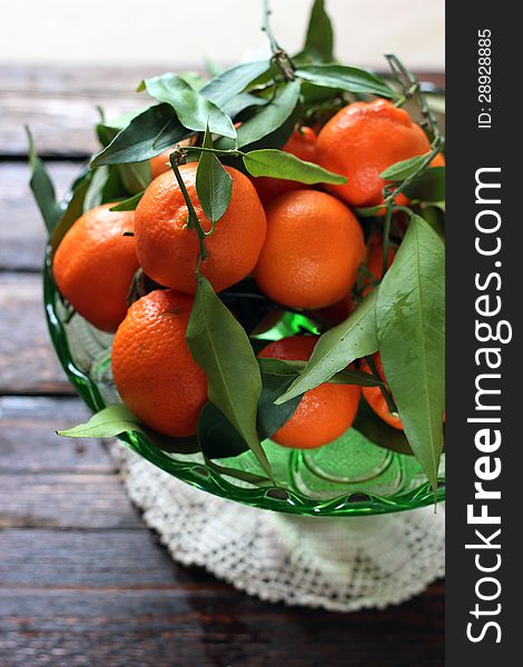 Bowl of fresh mandarins with leaves and branches. Bowl of fresh mandarins with leaves and branches