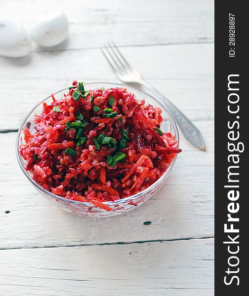 Buckwheat and beetroot salad on white wooden background. Buckwheat and beetroot salad on white wooden background