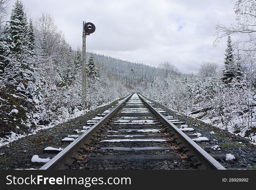 Railroad receding into the distance, amongst snowy forest. Railroad receding into the distance, amongst snowy forest.