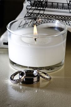 Vertical: Wedding Rings, White Candle, Table Decor Stock Photography