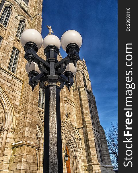 Lamp post in front of a church on a blue sky. Lamp post in front of a church on a blue sky