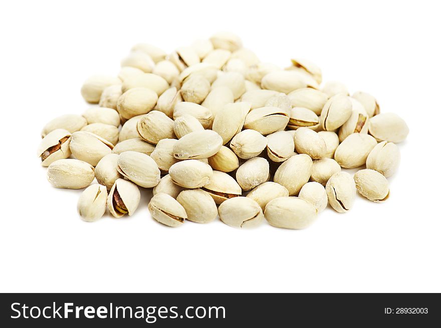 Dry salted pistachios on white background