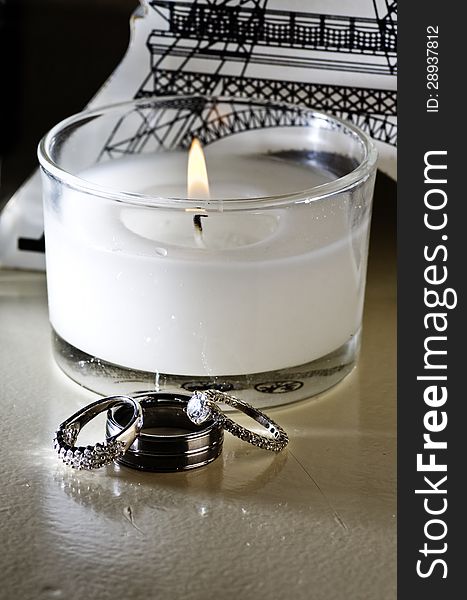 Vertical: Wedding Rings, White Candle, Table Decor