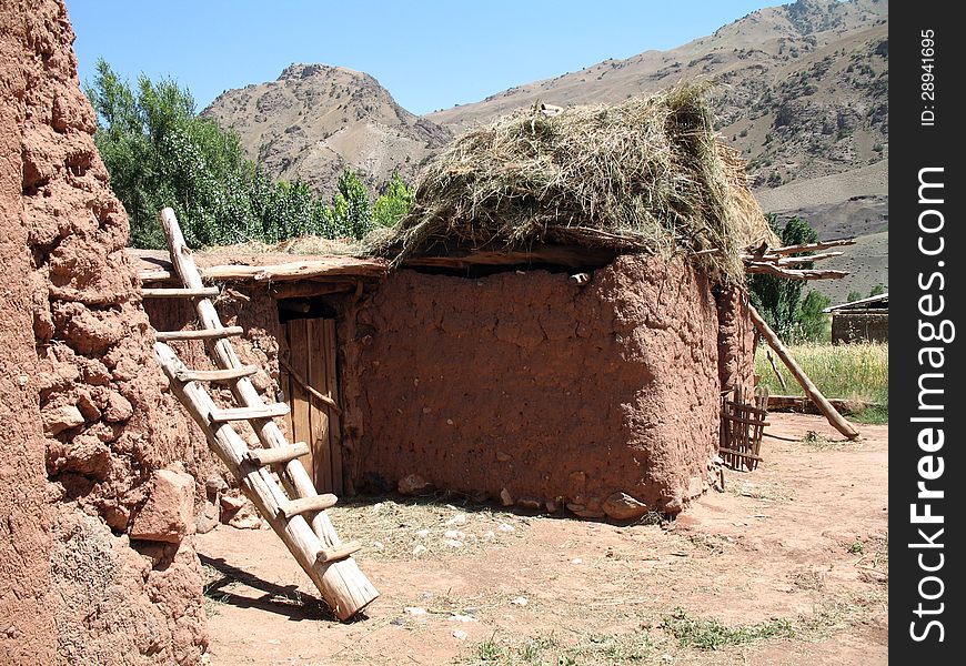 House of red clay located high in the mountains of Kyrgyzstan. House of red clay located high in the mountains of Kyrgyzstan