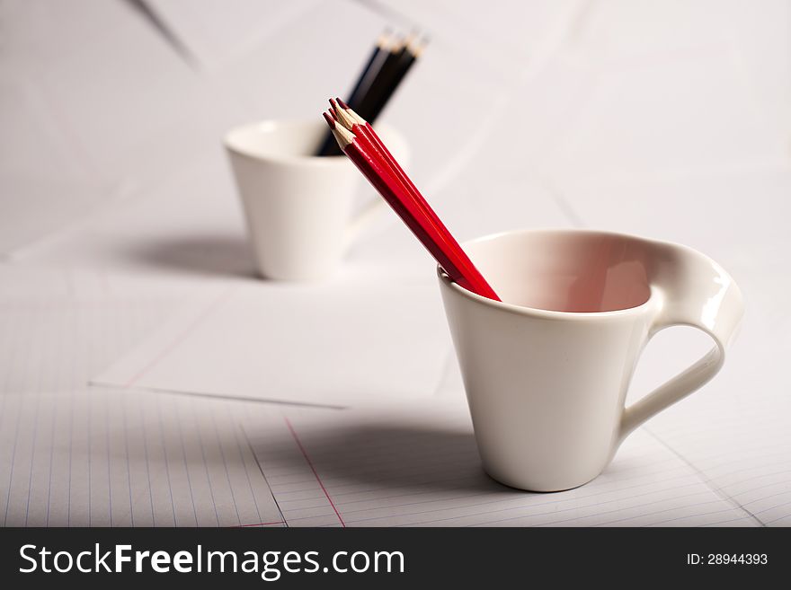 Black And Red Pencils Stand In Two Cups