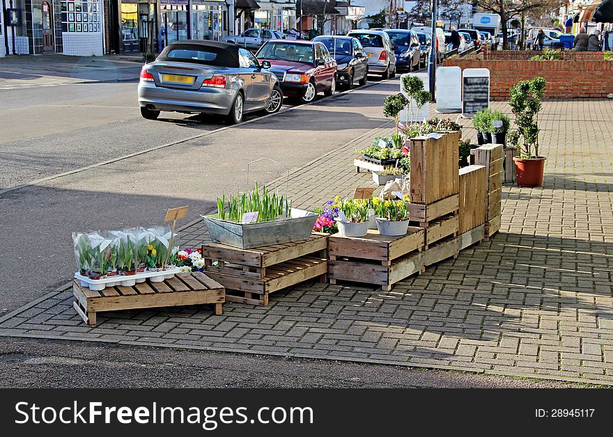 Photo of a high street flower seller with display on pavement outside shop. Photo of a high street flower seller with display on pavement outside shop.