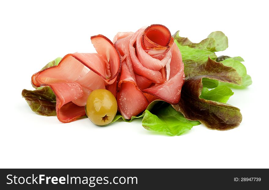 Curling Slices of Jamon on Lettuce Romano with Green Olive isolated on white background. Curling Slices of Jamon on Lettuce Romano with Green Olive isolated on white background