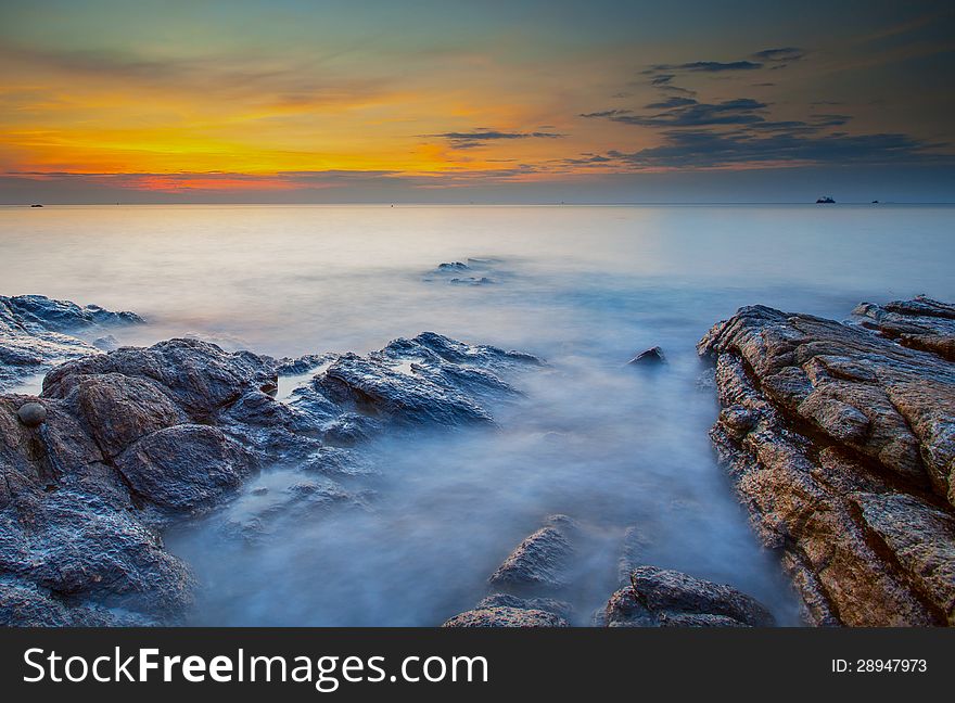 Colourful Sky of Sunrise Time, Blurred Wave and Rock at Pakarung (Coral) Beach, Samed Island, Rayong Province, Eastern of Thailand. Colourful Sky of Sunrise Time, Blurred Wave and Rock at Pakarung (Coral) Beach, Samed Island, Rayong Province, Eastern of Thailand