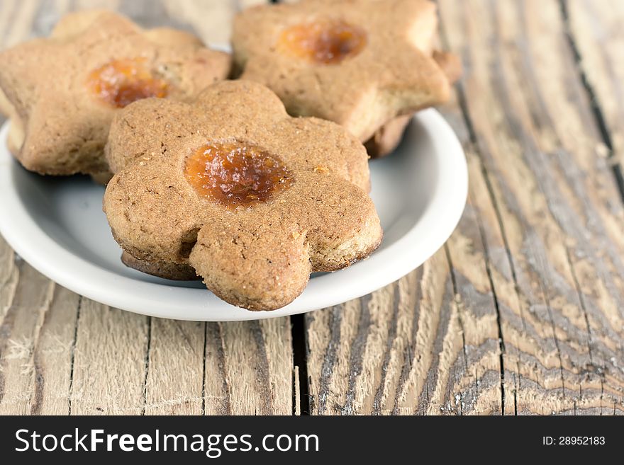 Almond cookies with fruit jam on table