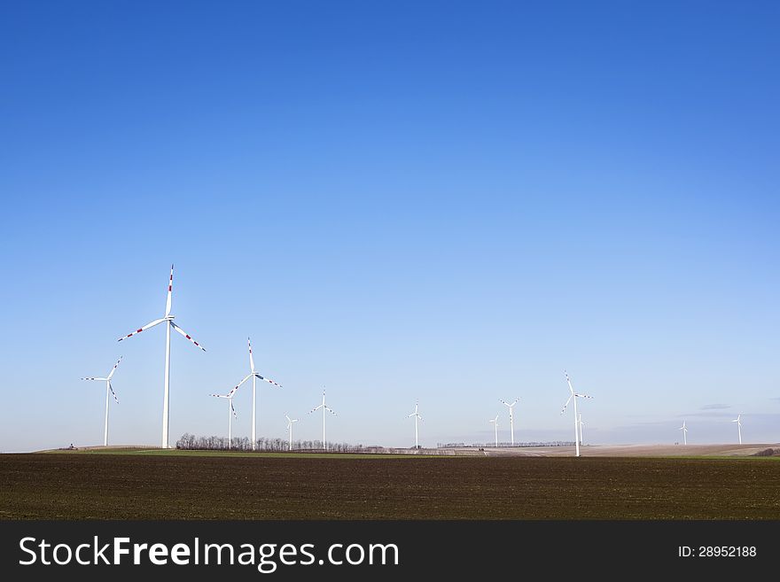 Power plant - wind farm - over clear blue sky