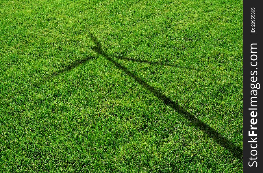 Wind Generator Turbine Shadow on the Grass