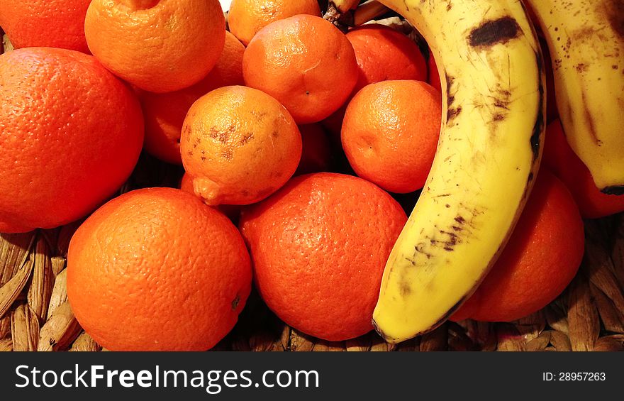 Orange and bananas on a wicker basket for food concepts. Orange and bananas on a wicker basket for food concepts