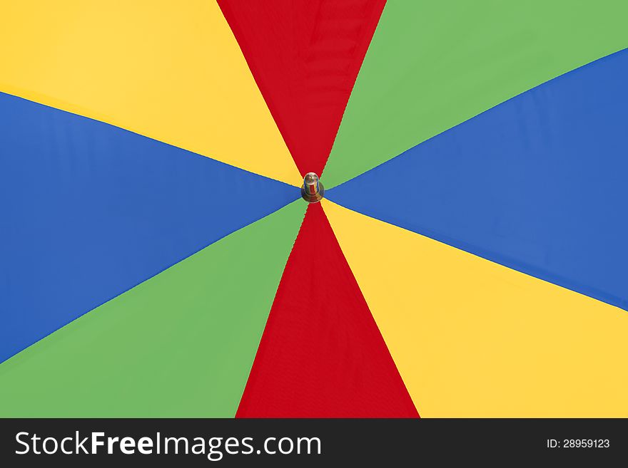 Very bright and bold colorful umbrella close up as a background. Very bright and bold colorful umbrella close up as a background.