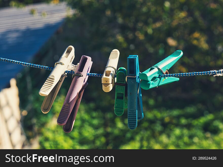 clothespins on a rope in the yard on a sunny day