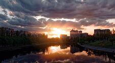 Sunset With Thick Clouds And Bright Glow Of Sun Setting Over Horizon Over River In City Of Kiev Stock Images Sunset With Thick Clouds And Bright Glow Of Sun Setting Over Horizon Over River In City Of Kiev Stock Images