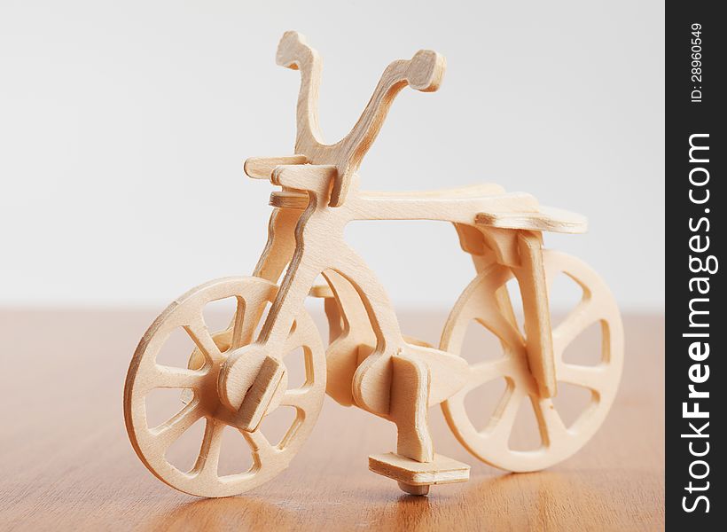 Wooden bicycle toy on table