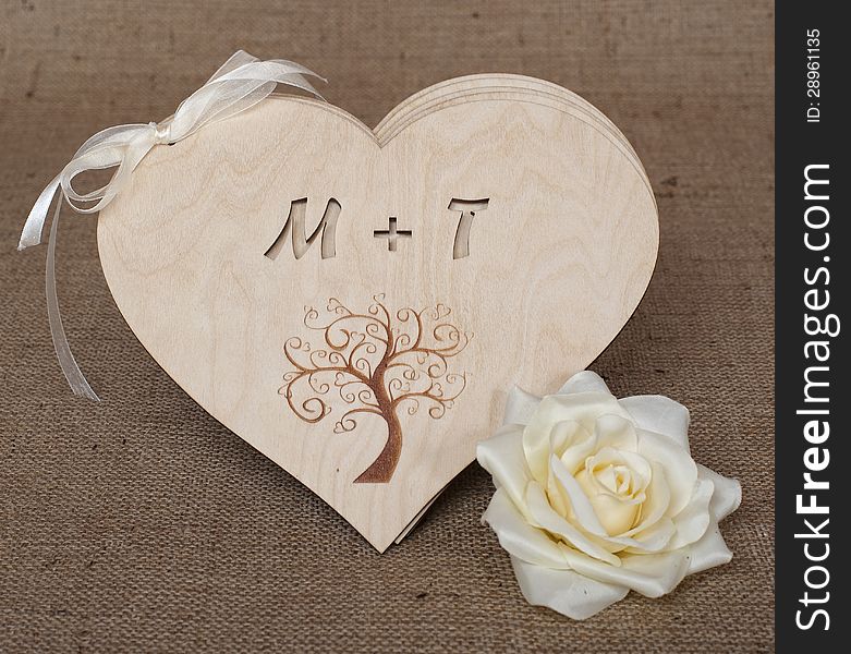 Wooden hearts with flower on natural burlap. Wooden hearts with flower on natural burlap