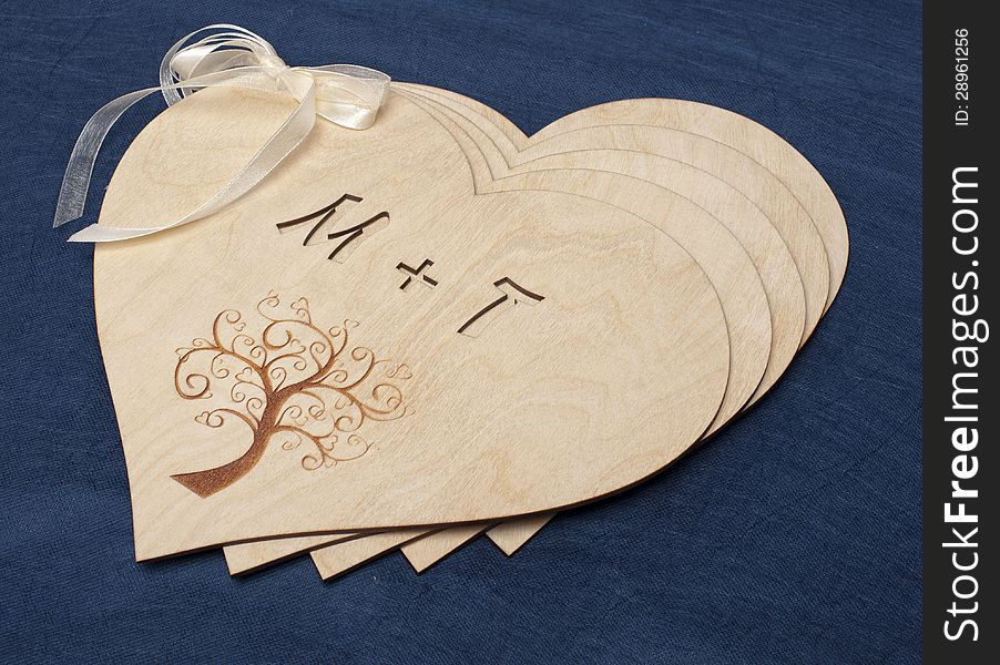 Five wooden hearts on blue background. Five wooden hearts on blue background
