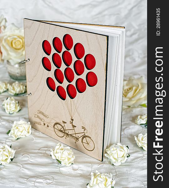 Wooden wedding guestbook with flowers in studio. Wooden wedding guestbook with flowers in studio
