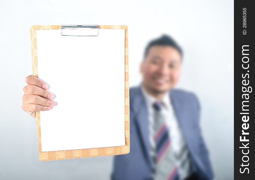 Business man showing note pad with blank paper