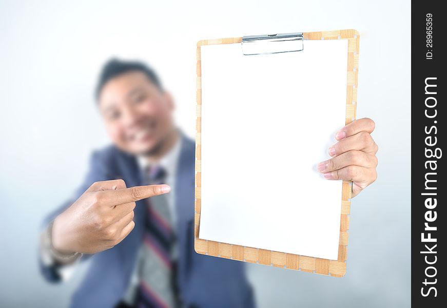 Business man showing note pad with blank paper