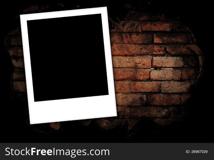 Photo frames on brick wall background.