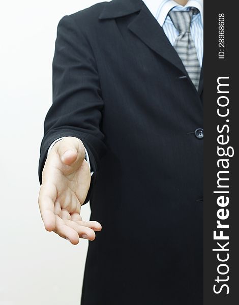 Business man with hand extended to handshake. Business man with hand extended to handshake