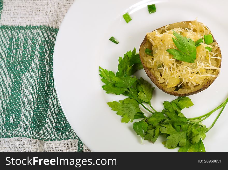 Baked potato with grated cheese and onions