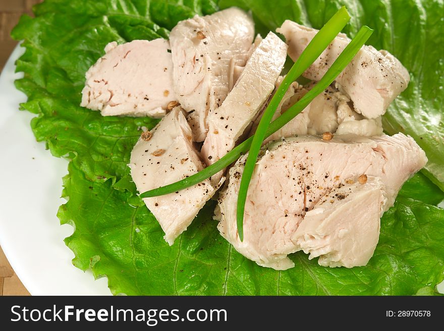 Boiled chicken with lettuce leaves