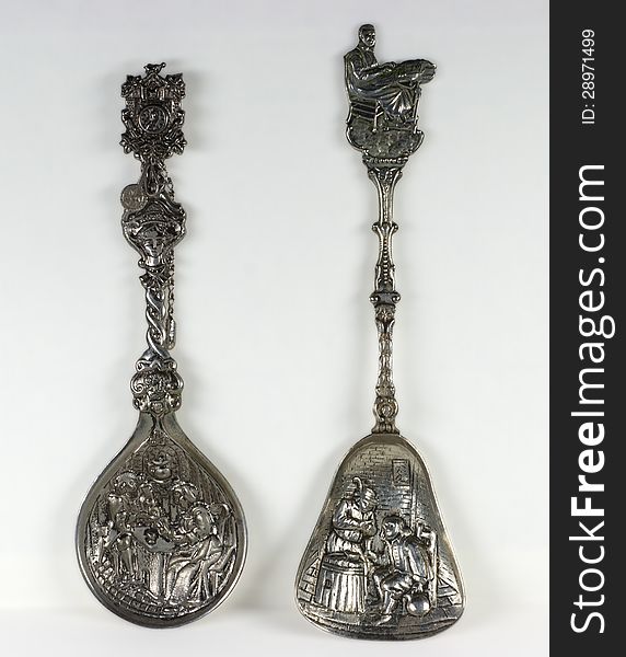 Two old rare antique silver teaspoons on light background. Two old rare antique silver teaspoons on light background