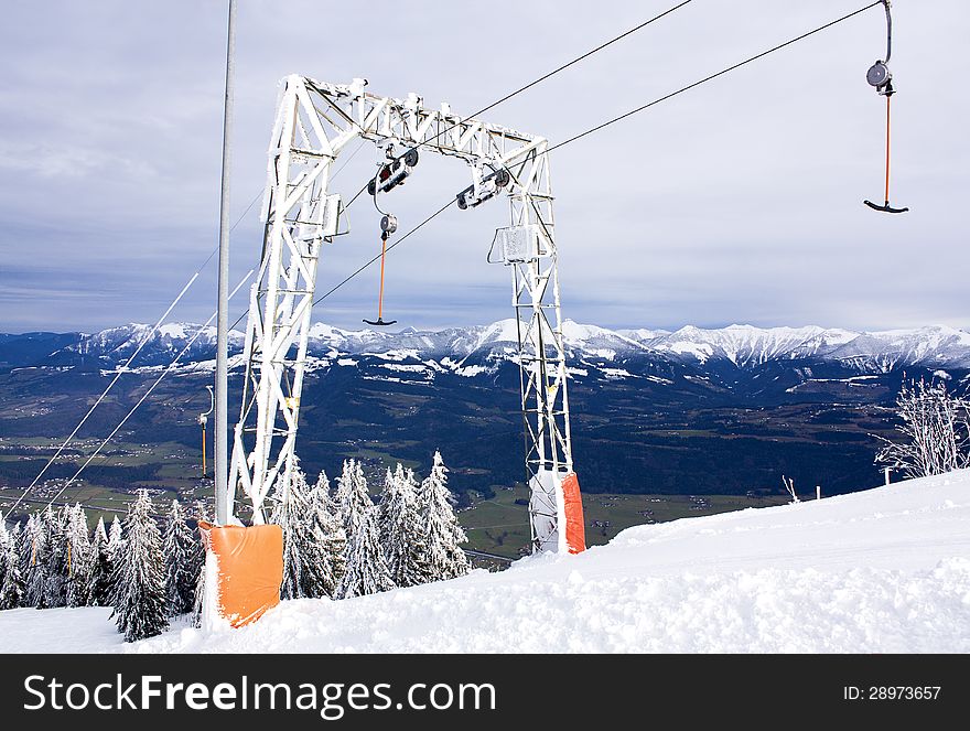 Rope tow ski lift against mountains. Rope tow ski lift against mountains