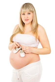 Pregnant Woman With Baby Shoes Stock Image Pregnant Woman With Baby Shoes Stock Image