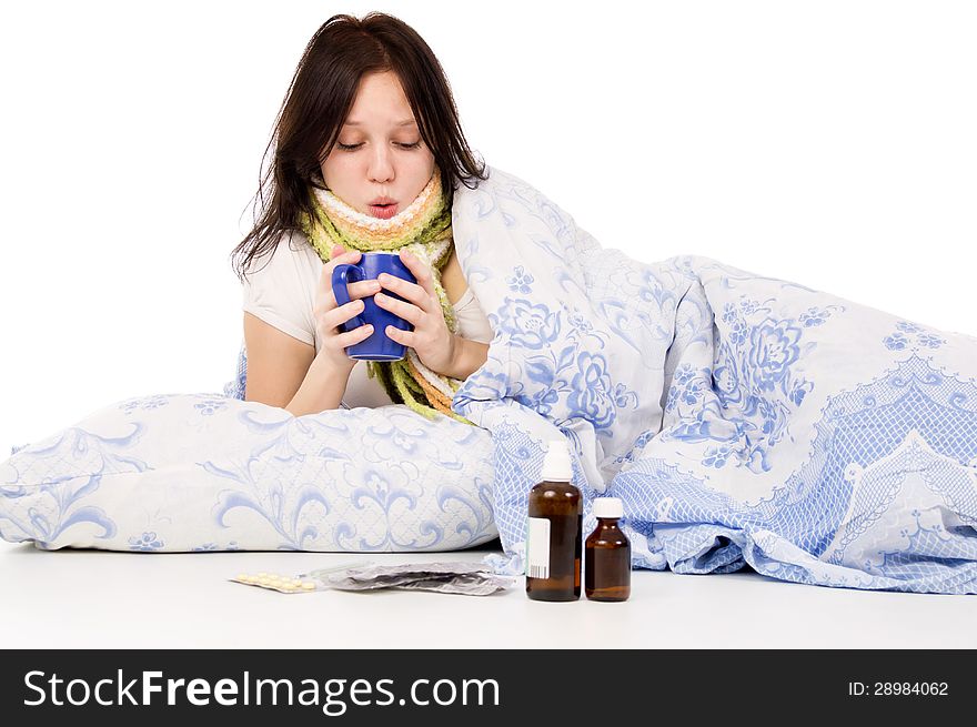 The sick girl lying in bed isolated on white background