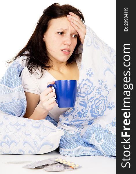 The diseased girl lying on the bed, and drink medicine on white background