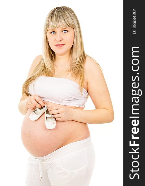 Pregnant woman with baby shoes