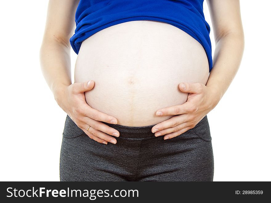 Detail of pregnant woman touching her abdomen