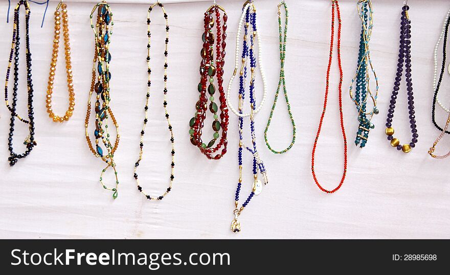 Colorful indian pearl necklaces displayed on white background