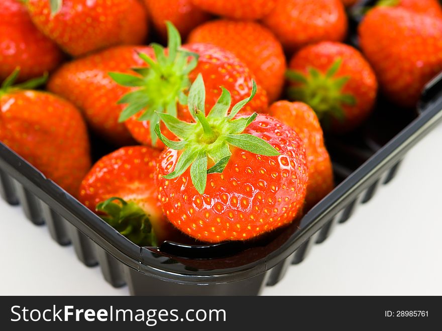 Fresh strawberries in a plastic box