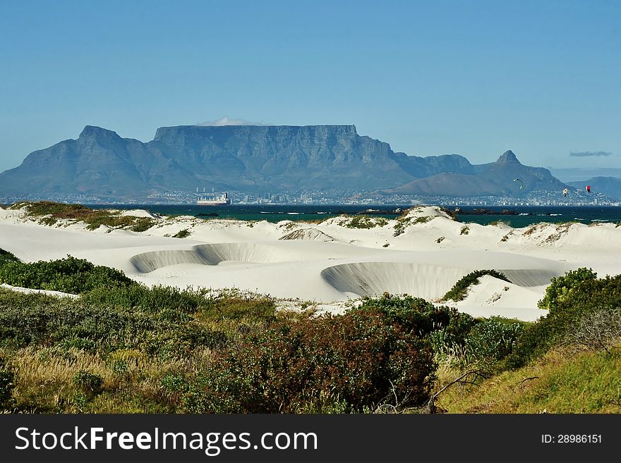 Landscape with white sand dune and Table mountain in the background