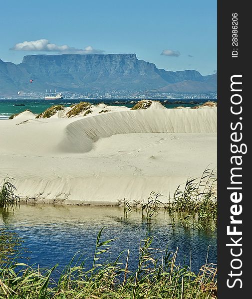 Landscape with white sand dune and Table mountain in the background