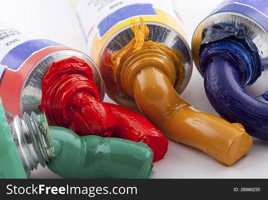 Oil paint of four colors squeezed out from the tube