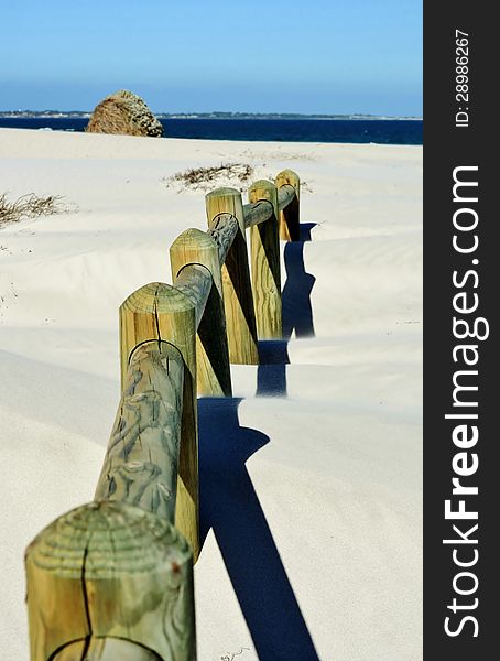 Landscape with wooden poles in white beach sand. Landscape with wooden poles in white beach sand