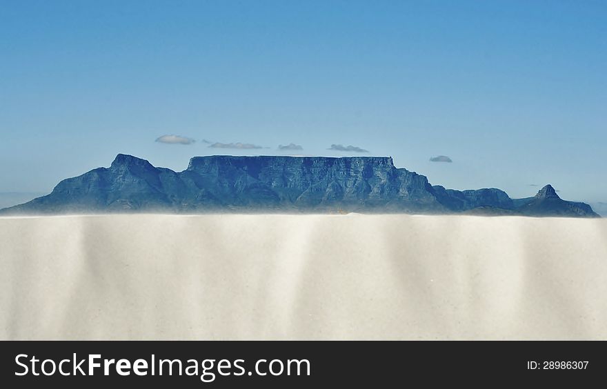 Landscape with white sand dune and Table mountain in the background. Landscape with white sand dune and Table mountain in the background