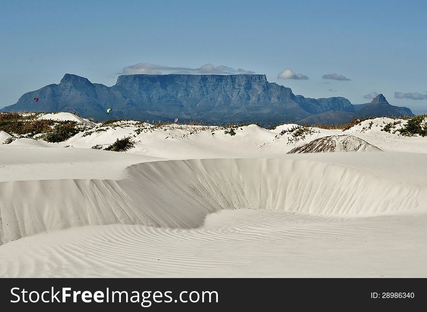 Landscape with white sand dune and Table mountain in the background